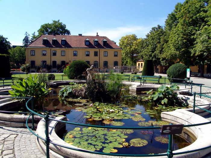 Palace garden with pond and building in Vienna, Austria