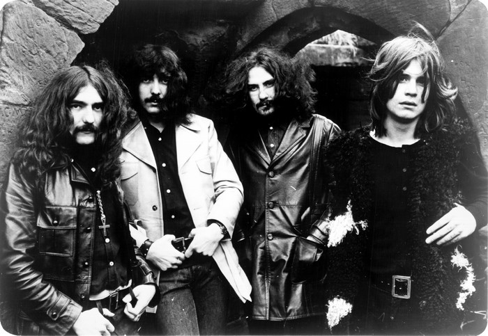 Black Sabbath band members posing outdoors
