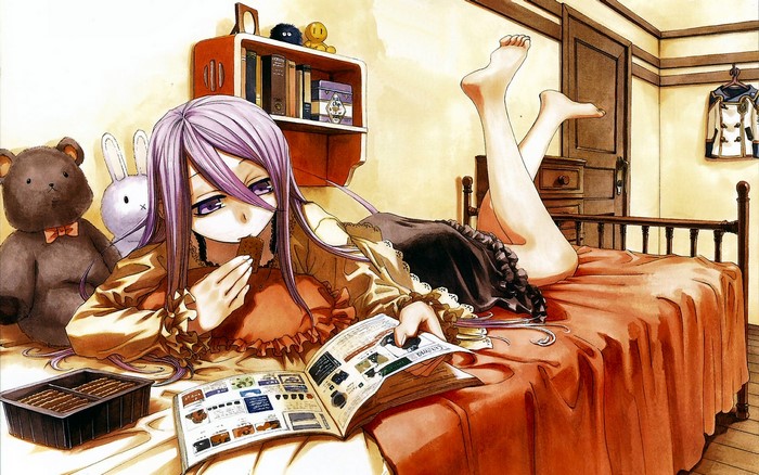 Girl eating chocolate in bed with books