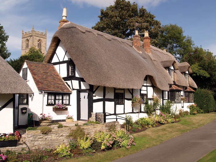 Thatched Cottages and Church Tower in the United Kingdom