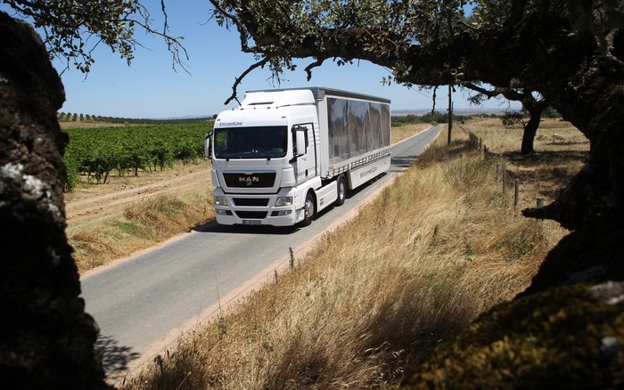 White MAN Truck driving on a rural road