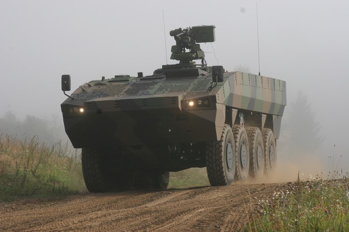 Armored personnel carrier driving on a dirt road