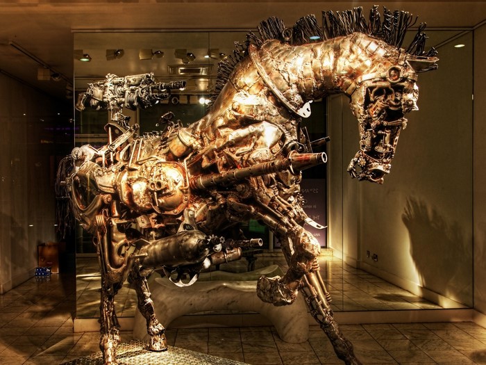 Steampunk metal horse sculpture with weapons
