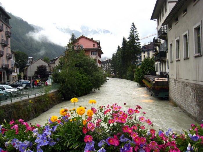 River flowing through a town in France with flowers