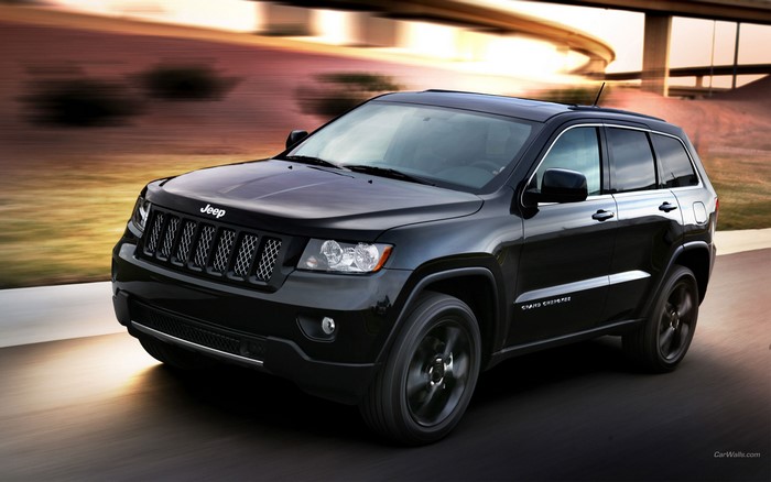Black Jeep Grand Cherokee driving on a road