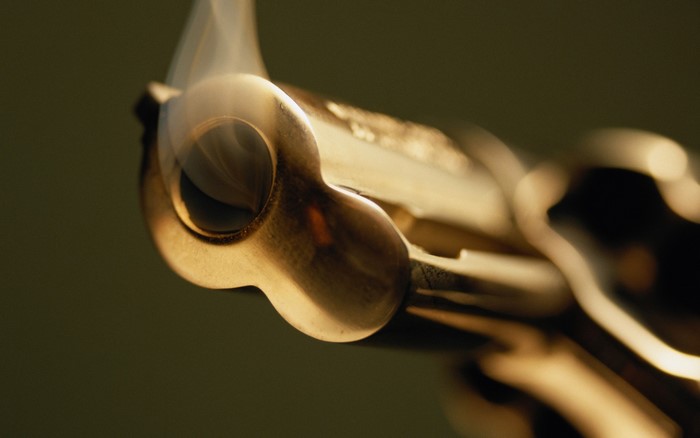 Close-up of a smoking gun barrel