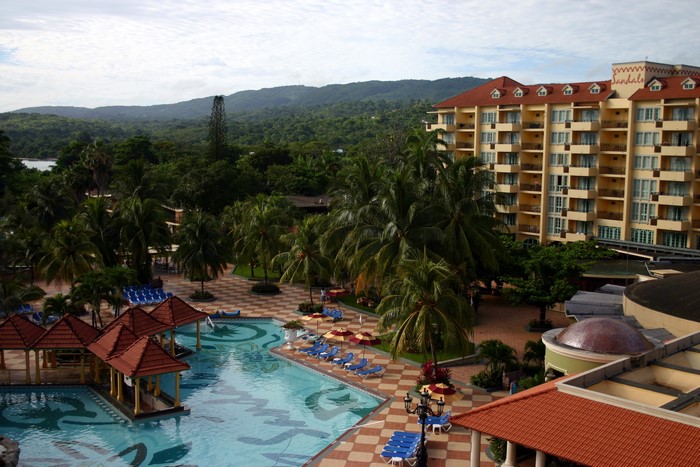 Resort with pools and palm trees overlooking mountains