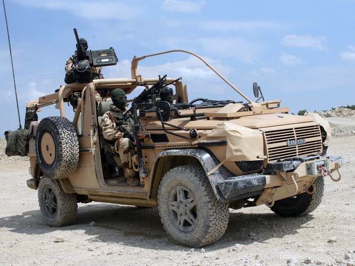 Military vehicle with soldiers and machine guns