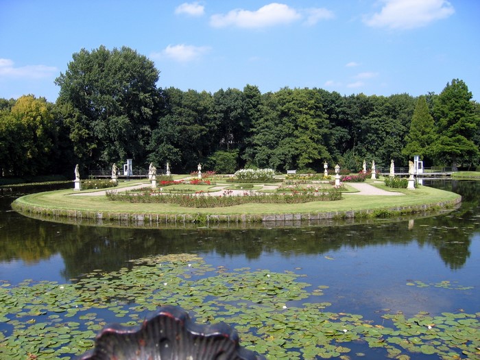 Formal garden with statues and pond