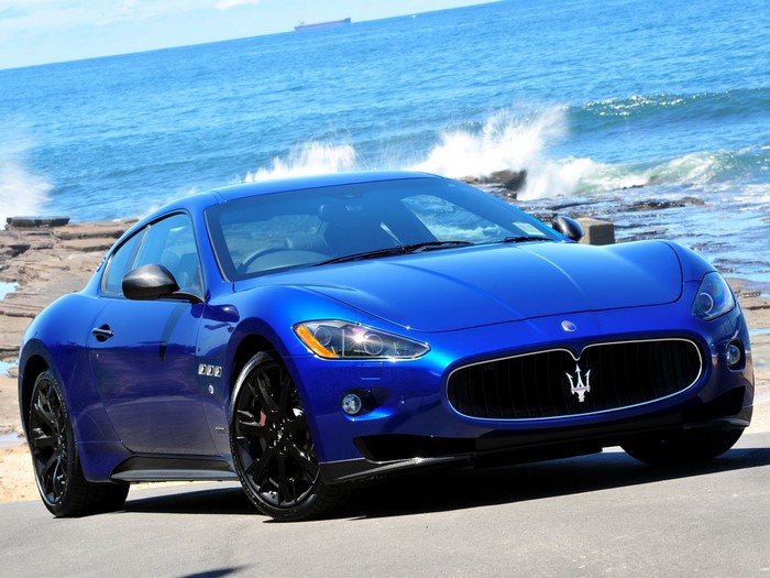 Blue Maserati GranTurismo parked by the ocean