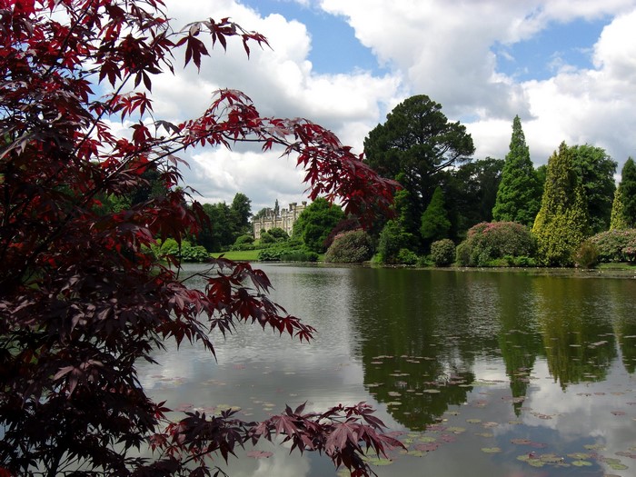Sheffield Park UK lake with trees and building