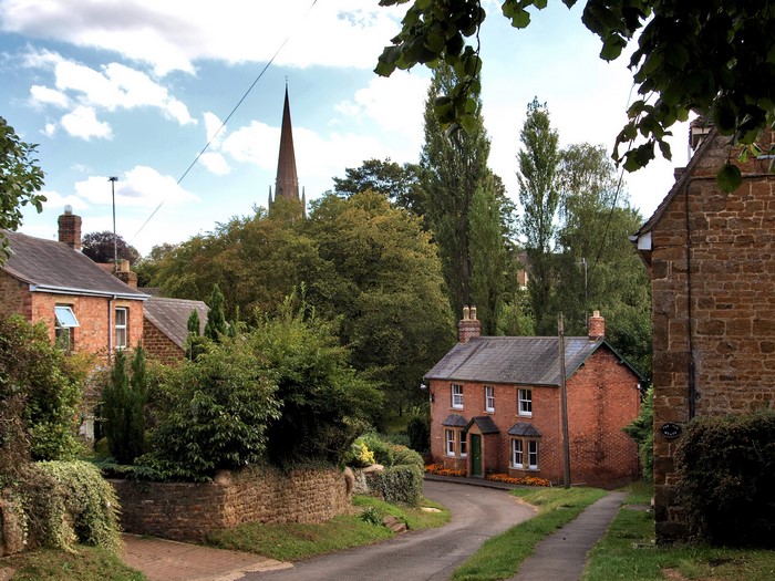Houses and church spire in a village in the United Kingdom