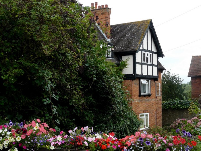 Tudor-style house with flowers and trees