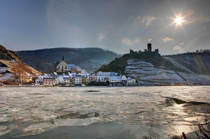 Frozen River and Village with Castle in Germany