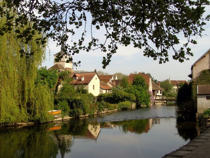 Village with church and river in France
