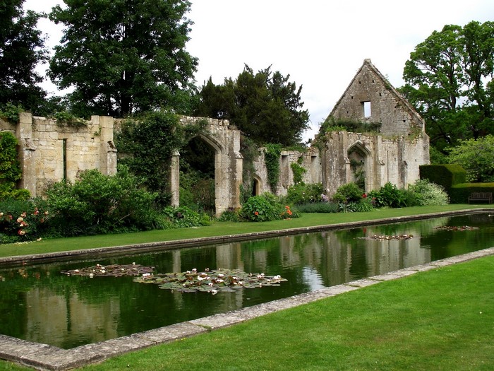 Ruins of Sudeley Castle with a formal garden and pond