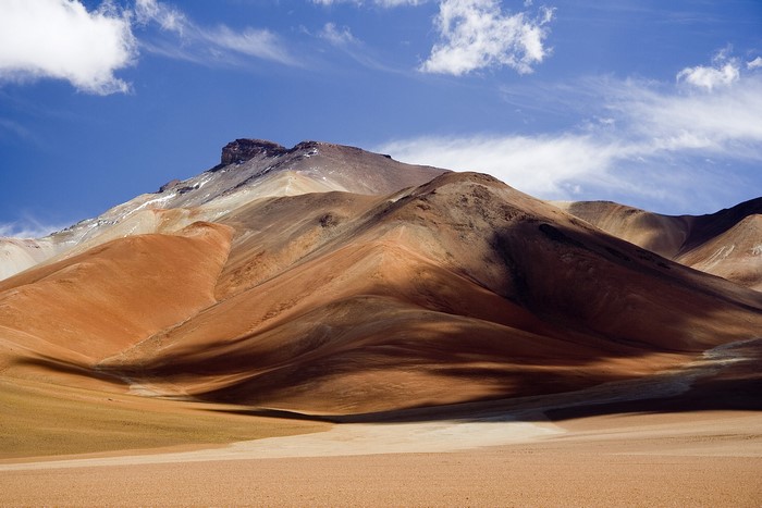 Altiplano mountains under a blue sky with clouds