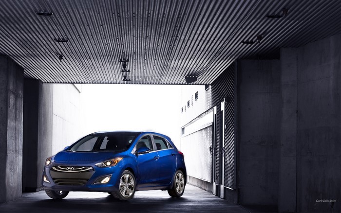 Blue Hyundai Elantra GT parked in a concrete structure