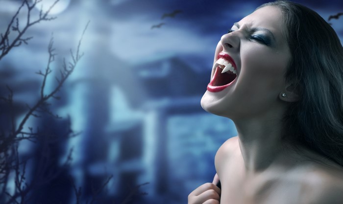 Vampire woman with fangs screaming