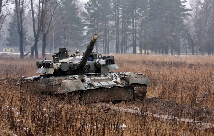 Tank in a muddy field with trees