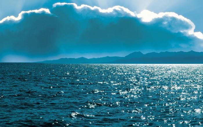 Ocean with Mountains and Clouds