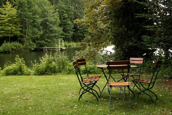 Outdoor table and chairs by a lake