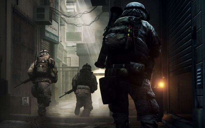 Soldiers in tactical gear in a war-torn alley