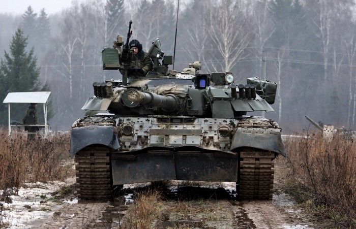 Tank with soldier in a wooded area