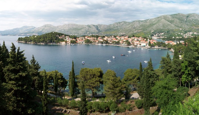 Coastal town with boats in the bay and mountains