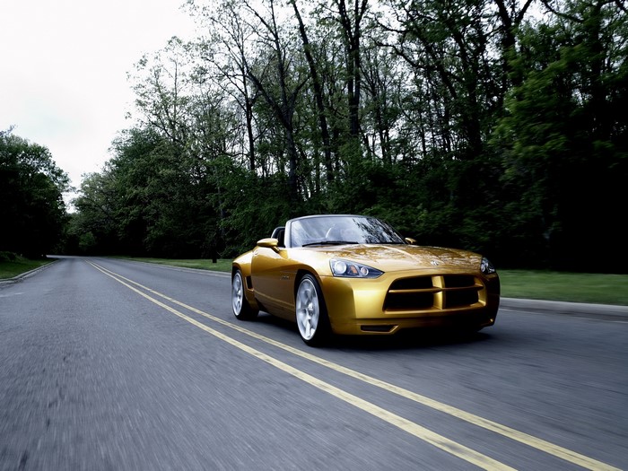 Golden Dodge Demon concept car driving on a road