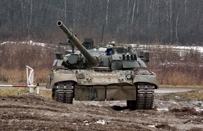 A muddy tank in a wooded area