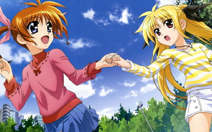 Two girls holding hands in front of a blue sky