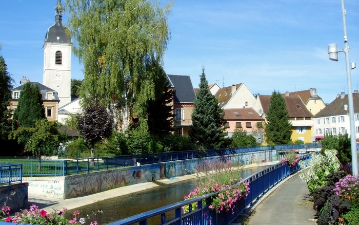 Riverfront with church tower in a French town