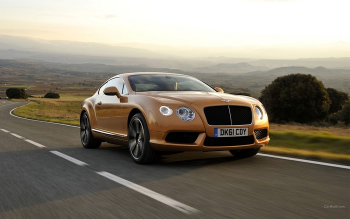 Bentley Continental GT driving on a scenic road