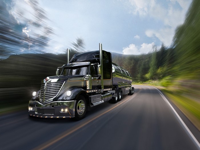 Black International LoneStar tanker truck driving on a road