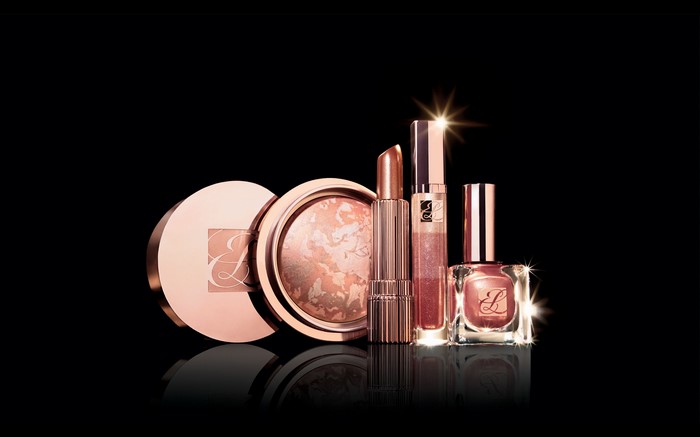 Estee Lauder makeup products on black background