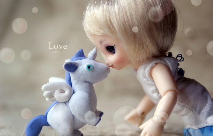 Doll kissing a clay unicorn