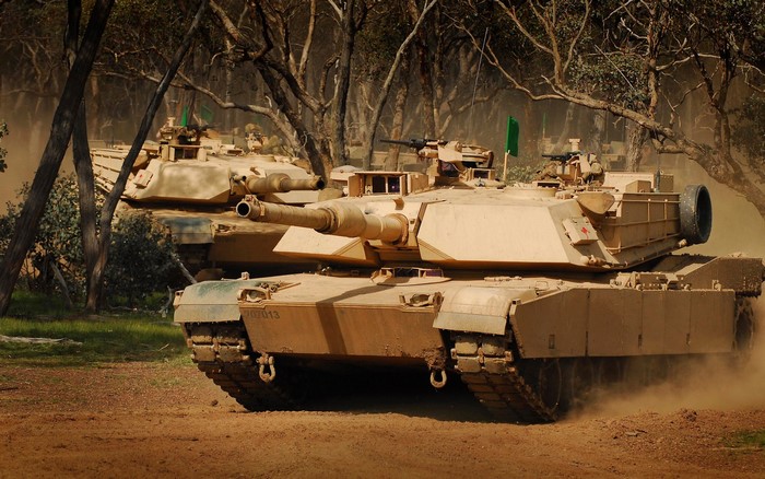 M1 Abrams tanks in a wooded area