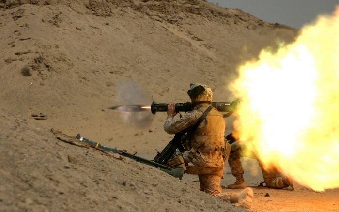 Soldier firing a rocket launcher in a desert