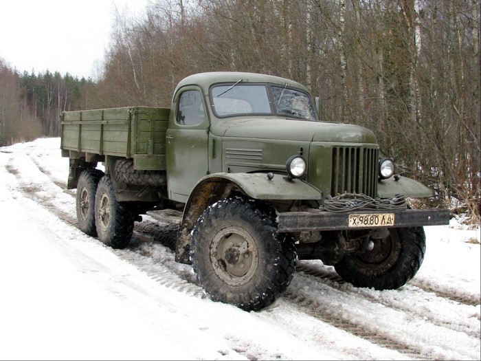 Green military truck on a snowy road