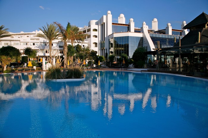 Resort with swimming pool and palm trees