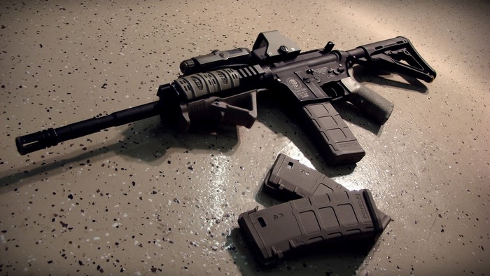Assault rifle with magazines on floor