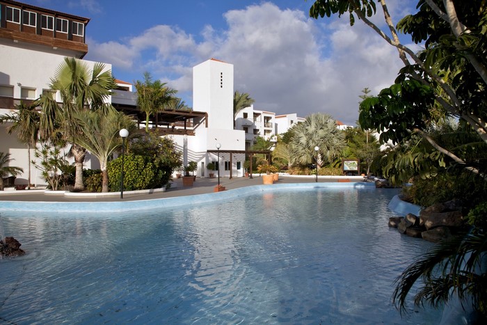 Resort with swimming pool and palm trees