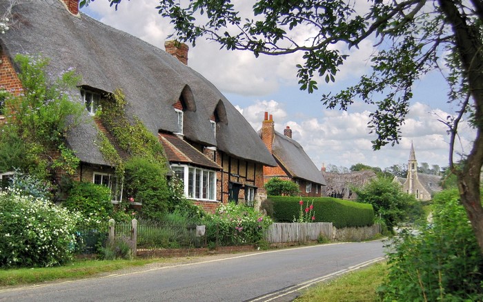 Thatched roof cottages and church in the United Kingdom