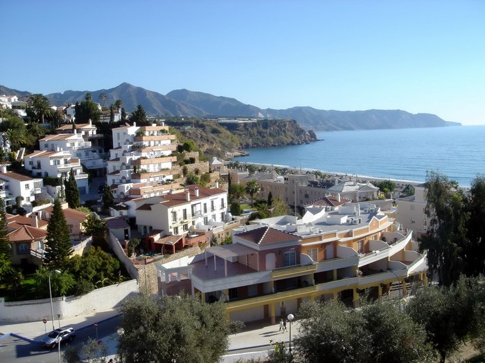 Coastal town with white buildings and the sea in Spain