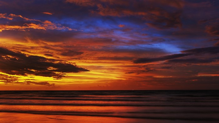 Sunset over the ocean with colorful clouds