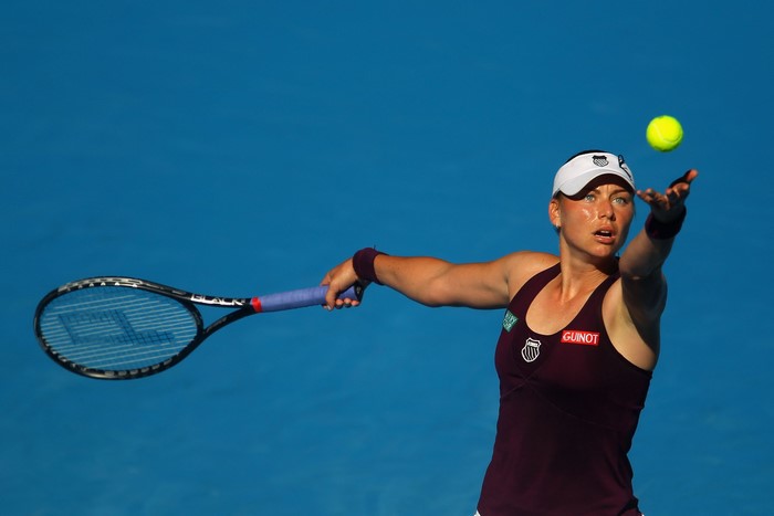 Tennis player serving a ball