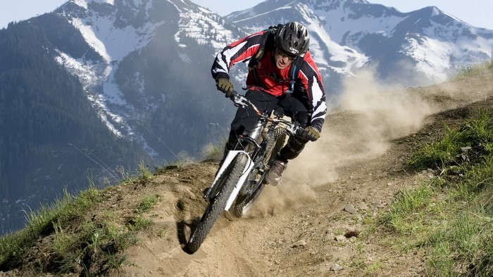 Mountain biker riding downhill on a dirt path