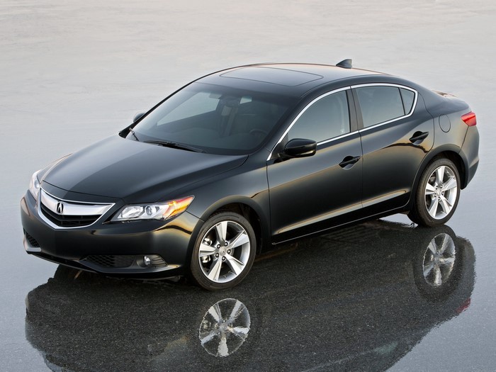 Black Acura sedan parked on wet surface