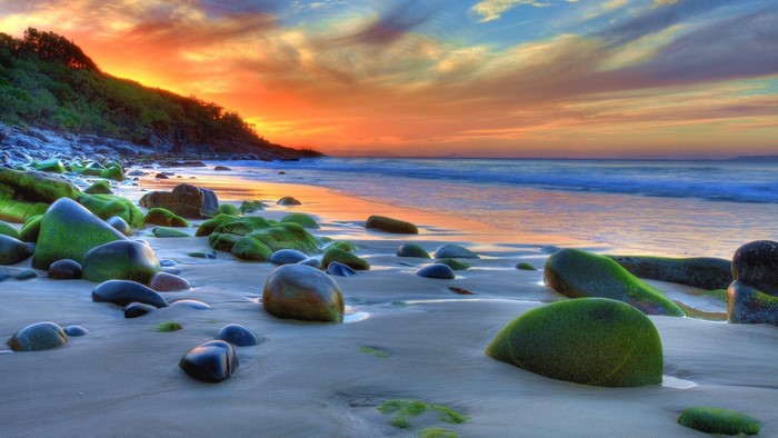 Beach with rocks and sunset